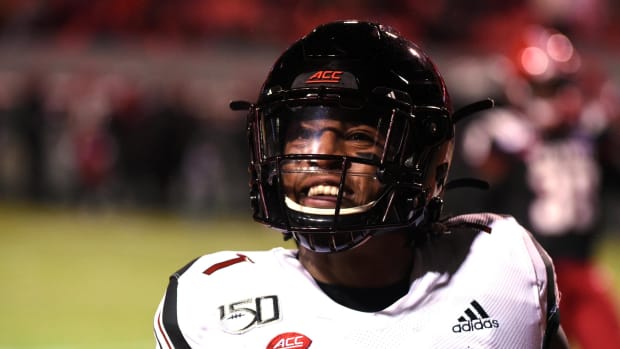 Louisville Cardinals receiver Dez Fitzpatrick (7) reacts after scoring a touchdown during the first half against the North Carolina State Wolfpack at Carter-Finley Stadium.